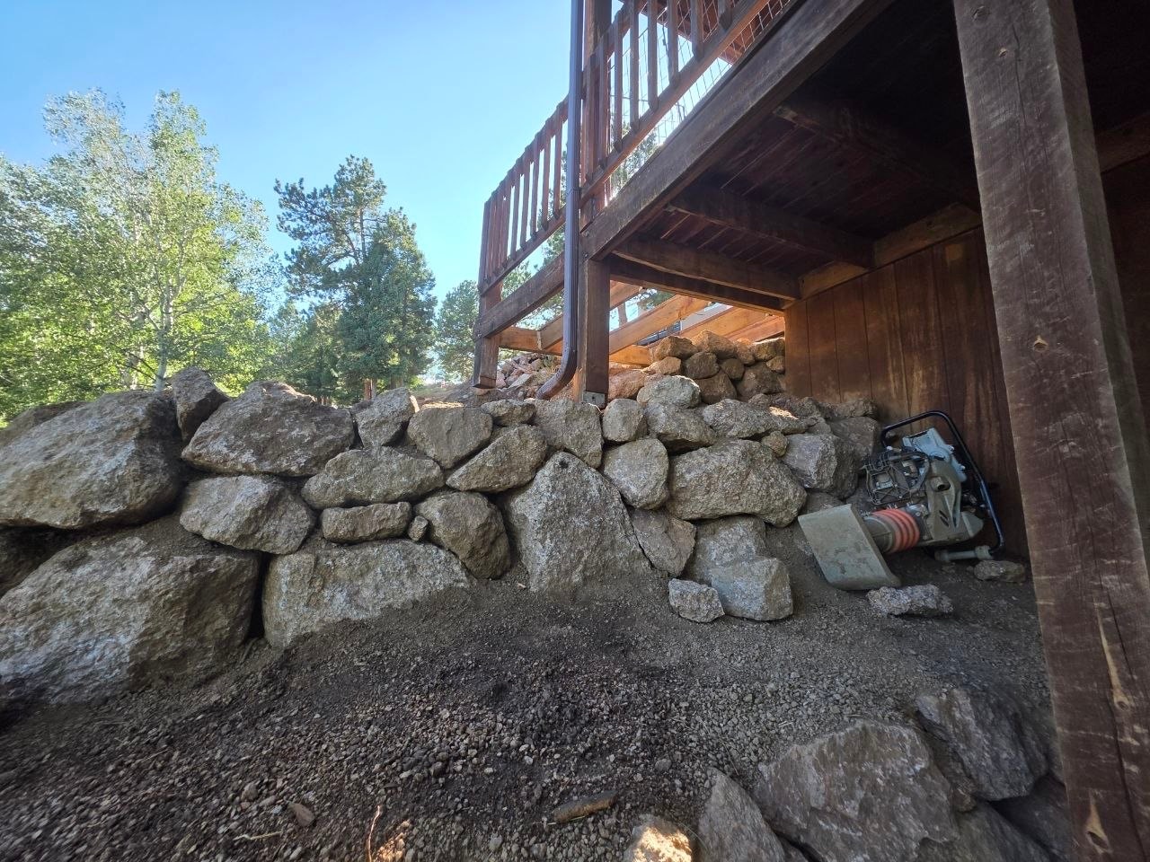 Boulder wall transition from under deck to exposed wall, Woodland Park CO — Oakden Enterprises