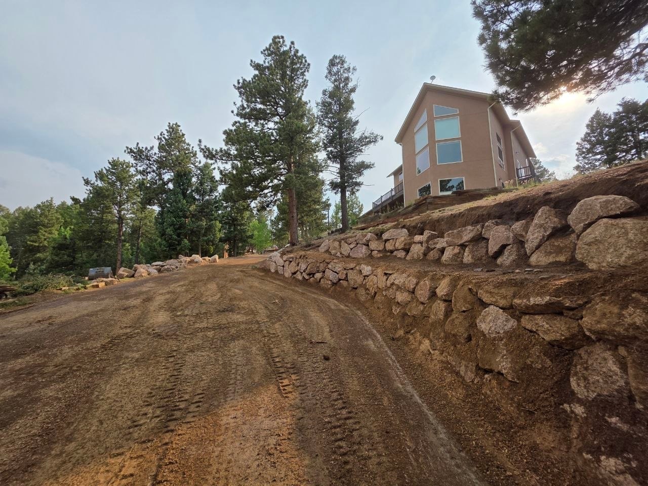 Boulder wall and home on hillside, Woodland Park CO — Oakden Enterprises