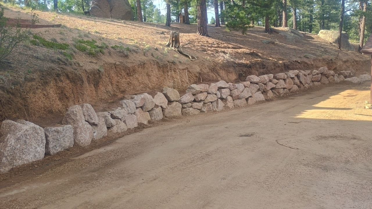 Driveway boulder wall under construction, Woodland Park CO — Oakden Enterprises