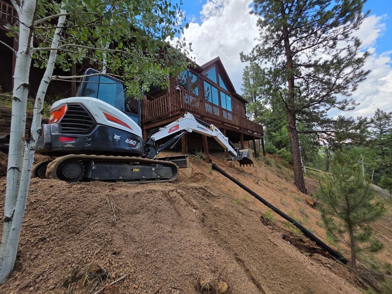 Bobcat E60 performing multi-tier terracing on hillside — Oakden Enterprises