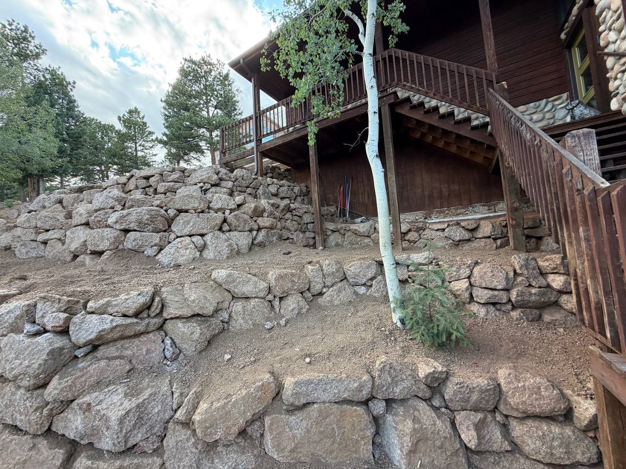 Multi-tier boulder wall system around home foundation, Woodland Park CO — Oakden Enterprises