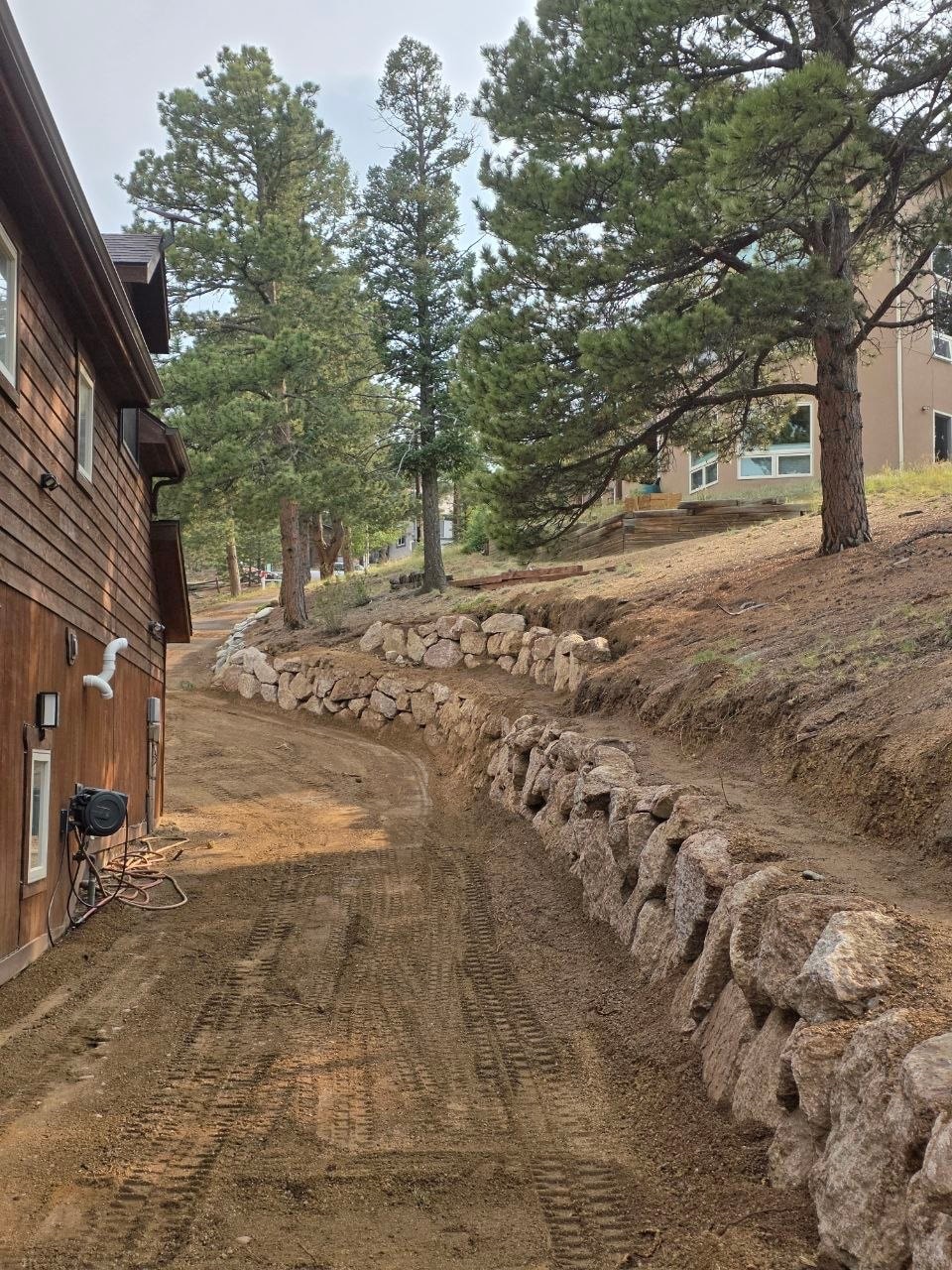 Dual-tier driveway boulder walls under construction — Oakden Enterprises