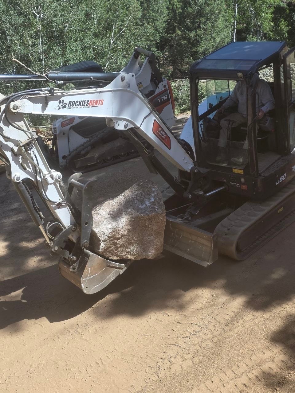 Bobcat E60 moving and placing boulders on site — Oakden Enterprises